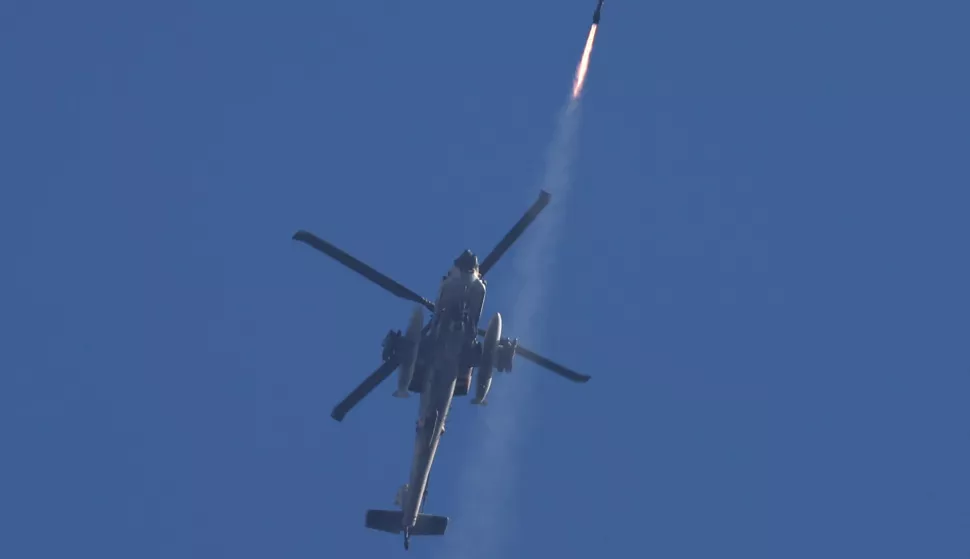 epa11642035 An Israeli Apache helicopter fires a missile toward targets in southern Lebanon, as seen from the Upper Galilee, northern Israel, 04 October 2024. The Israeli army reported that multiple projectiles were identified crossing from Lebanon to the the Upper Galilee area, with some of the projectiles successfully intercepted while others fell in open areas. EPA/ATEF SAFADI