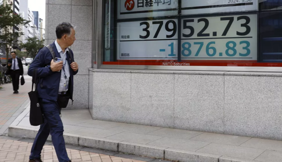 epa11633250 A passerby walks past a stock market indicator board in Tokyo, Japan, 30 September 2024. The Tokyo stock index plunged over 4 percent following remarks from Shigeru Ishiba, the newly elected ruling Liberal Democratic Party president, and expected Japan's prime minister, who had advocated for strengthening financial income taxation during the LDP presidential election. EPA/FRANCK ROBICHON