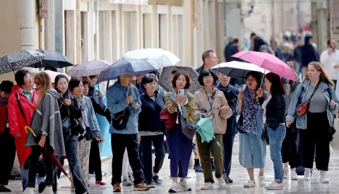 Zadar, 28.09.2024. - Kišno vrijeme koje je bilo tijekom subotnjeg prijepodneva nije smetalo brojnim turistima za šetnju po zadarskom Poluotoku.Foto HINA/Zvonko KUCELIN