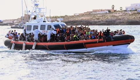 epa10868029 Migrants crowd the deck of the Italian Coast Guard patrol boat CP327 as it arrives in the port of Lampedusa, 18 September 2023. More than 1,000 migrants remain in the hotspots of Lampedusa where they await transfer. Italian Deputy Premier and Foreign Minister Antonio Tajani on 15 September called for the intervention of the United Nations in response to the significant increase in the arrival of migrants and refugees by sea to Italy in recent days. EPA/CIRO FUSCO