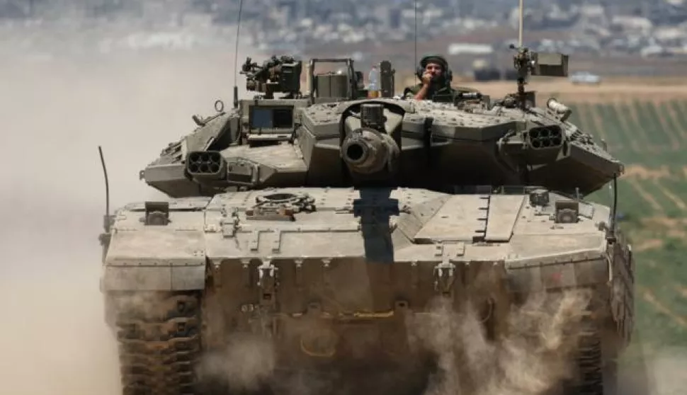 epa11344328 Israeli tanks patroll near the security fence with Jabalia in the northern part of the Gaza Strip, in the background, southern Israel, 16 May 2024. More than 35,100 Palestinians and over 1,455 Israelis have been killed, according to the Palestinian Health Ministry and the Israel Defense Forces (IDF), since Hamas militants launched an attack against Israel from the Gaza Strip on 07 October 2023, and the Israeli operations in Gaza and the West Bank which followed it. EPA/ATEF SAFADI