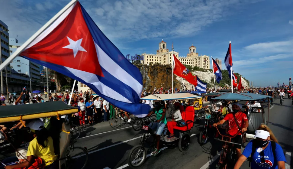 epa09398517 Cubans participate in a march in support of the Cuban revolution through the Malecon area in Havana, Cuba, 05 August 2021. Cubans took to the streets in Cuba on 11 July to protest the government response to the COVID-19 pandemic, shortages of medicines and basic commodities, and decliing infrustructure on the island nation. EPA/Ernesto Mastrascusa