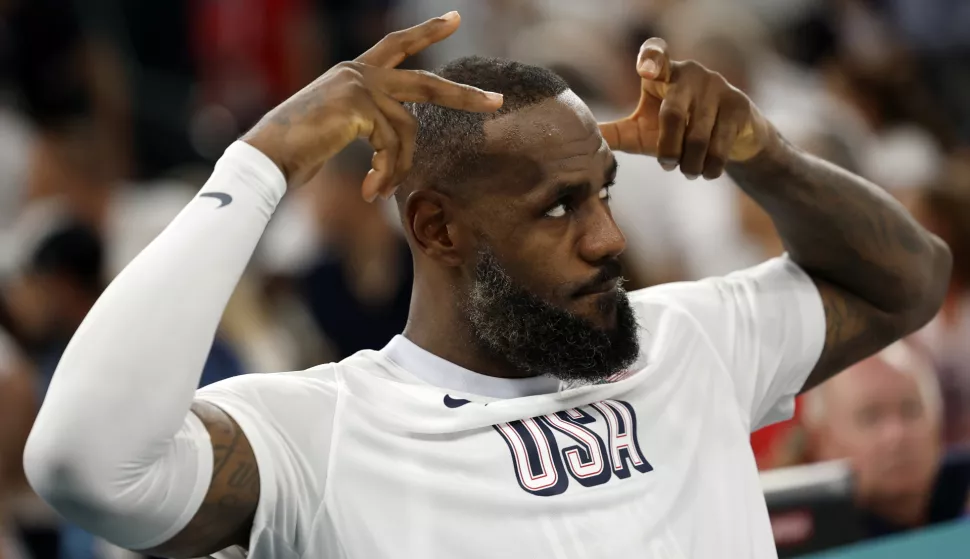 epaselect epa11531903 LeBron James of the US makes a crown gesture during the men's quarterfinal match between Brazil and USA in the Basketball competitions in the Paris 2024 Olympic Games, at the South Paris Arena in Paris, France, 06 August 2024. EPA/CAROLINE BREHMAN