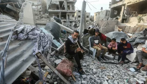 12 November 2023, Palestinian Territories, Rafah: Palestinian flautist Imad Al-Rabiah, plays among his children on the ruins of his destroyed house in Rafah. The displaced Al-Rabiah family of eight live on the remains of their house in Rafah, after it was destroyed by Israeli bombing and they failed to find a shelter in the crowded UNRWA schools or with their relatives. Photo: Mohammed Talatene/dpa Photo: Mohammed Talatene/DPA