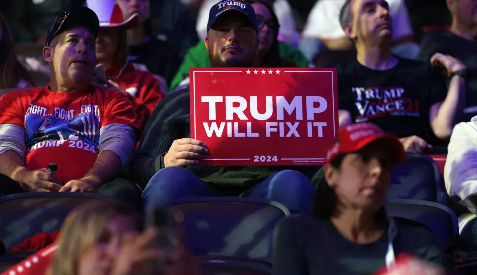 epaselect epa11701301 Supporters wait for former US President Donald Trump to attend a rally in Reading, Pennsylvania, USA, 04 November 2024. Trump and US Vice President and Democratic presidential candidate Kamala Harris are tied in the polls ahead of the US presidential election on 05 November. EPA/WILL OLIVER