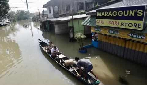 epa11717572 Villagers on a wooden boat paddle on a flooded village caused by Typhoon Toraji in Tuguegarao city, Cagayan city, Philippines, 13 November 2024. Typhoon Usagi, the fourth to barrel the Philippines, intensified into a typhoon before dawn on 13 November, as it threatened to hit land on 14 November will bring more rains to northern Luzon island after the onslaught of Typhoons Toraji, Trami, and Kong-Rey. EPA/FRANCIS R. MALASIG