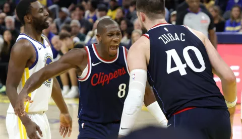 epa11688467 LA Clippers guard Kris Dunn (C) reacts to a basket of teammate Ivica Zubac against the Golden State Warriors during the second half of an NBA game in San Francisco, California, USA, 27 October 2024. EPA/JOHN G. MABANGLO SHUTTERSTOCK OUT