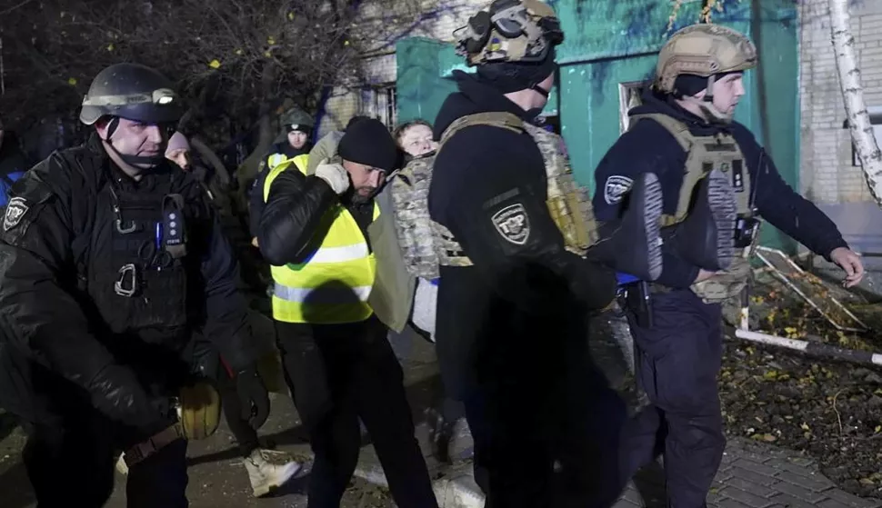 epa11726610 A handout photo released by the press service of the State Emergency Service of Ukraine shows Ukrainian rescuers escort an injured person at the site of a rocket hit on a residential building in Sumy, Ukraine, 17 November 2024. At least 10 people were killed, including two children, and 51 others were injured during the evening rocket attack a nine-storey residential building according the State Emergency Service (SES) of Ukraine. Russian troops entered Ukrainian territory on 24 February 2022, starting a conflict that has provoked destruction and a humanitarian crisis. EPA/STATE EMERGENCY SERVICE HANDOUT 69086HANDOUT EDITORIAL USE ONLY/NO SALES