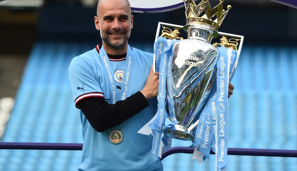 epa10644642 Manchester City manager Pep Guardiola poses with the English Premier League trophy after the English Premier League match between Manchester City and Chelsea FC in Manchester, Britain, 21 May 2023. EPA/PETER POWELL EDITORIAL USE ONLY. No use with unauthorized audio, video, data, fixture lists, club/league logos or 'live' services. Online in-match use limited to 120 images, no video emulation. No use in betting, games or single club/league/player publications.