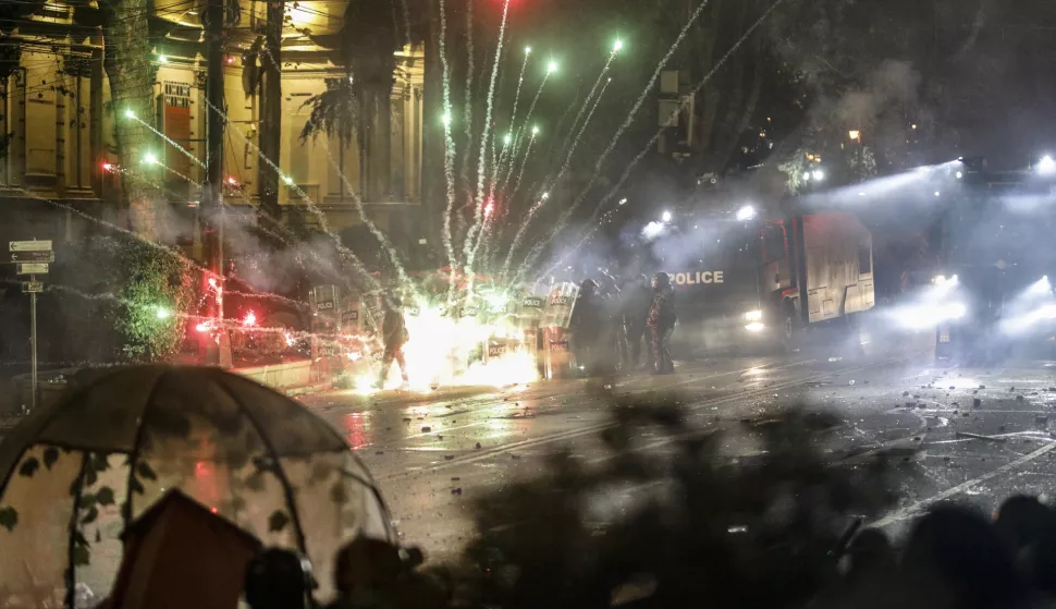 epa11748614 Georgian opposition supporters launch fireworks towards the police during a protest in front of the Parliament building in Tbilisi, Georgia, 30 November 2024. Georgian Prime Minister Kobakhidze said on 28 November that Tbilisi will refuse EU accession talks until 2028. The ruling Georgian Dream Party was announced as the winner of the parliamentary elections held on 26 October 2024. EPA/DAVID MDZINARISHVILI