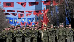 epa10472696 Soldiers march during the official military parade on the occasion of Kosovo's independence anniversary in Pristina, Kosovo, 17 February 2023. Kosovo is marking 15 years since proclaiming independence from Serbia on 17 February 2008. EPA/Georgi Licovski