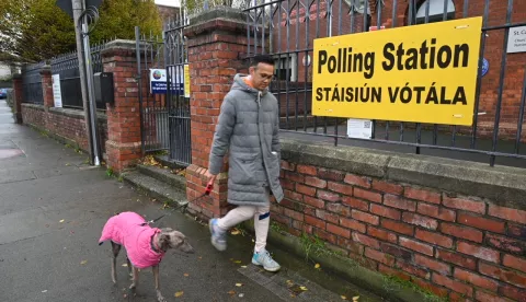 epa11747715 A person with a dog passes a polling station in Dublin, Ireland, 29 November 2024. Ireland is holding a general election on 29 November to elect 174 seats across 43 constituencies for the Dail (Ireland's lower house of parliament). Ireland uses a system of proportional representation where candidates are ranked by preference and the voting slips will need to be counted several times. Some constituencies might see their count lasting several days. EPA/BRYAN MEADE