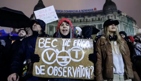 epa11748603 Romanian protesters shout slogans and hold up placards while braving the rain during a protest at the University Plaza, against far-right independent presidential candidate Calin Georgescu, in central Bucharest, Romania, 29 November 2024. Students and civil rights activists continue their protests against the far-right independent runoff candidate Calin Georgescu, whose declarations worried human right activists. Romania's Constitutional Court (CCR) on 28 November instructed the Central Electoral Bureau (BEC) to recount all ballots from the first round of presidential elections held on 24 November, following complaints from two candidates. On 29 November the court announced that the final decision had been postponed until 02 December, the day after the Parliamentary elections. The placard reads: 'BEC, ARE YOU AFRAID OF OBSERVERS?'. EPA/ROBERT GHEMENT