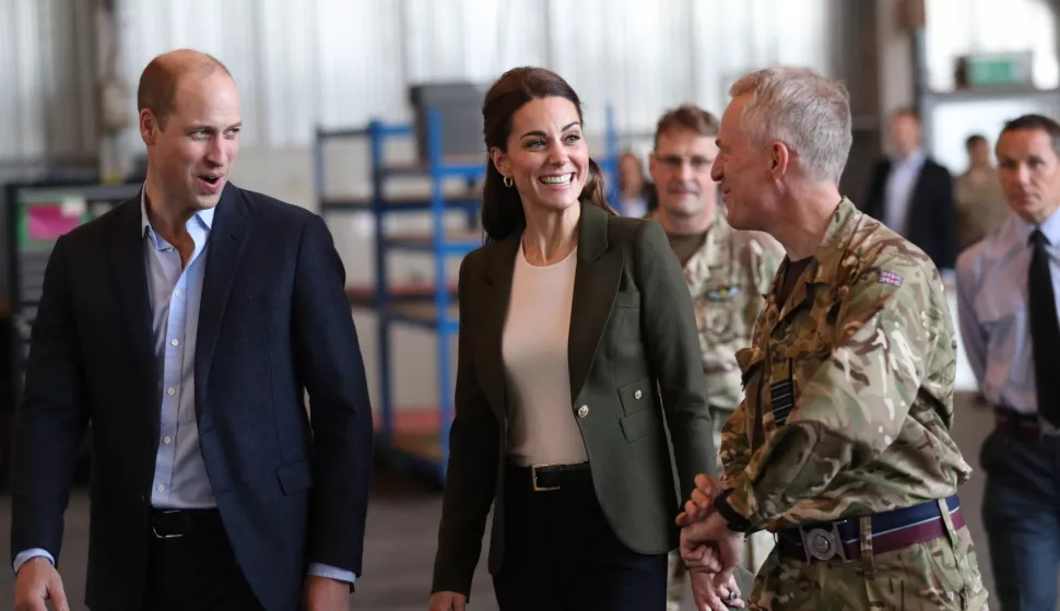 epa07209994 Britain's Prince William, Duke of Cambridge (L) and Catherine, Duchess of Cambridge (C) meet members of 31 SQN and other operational personnel in a hangar at RAF Akrotiri in Cyprus, 05 December 2018. The Duke and Duchess carry out a series of engagements on the Royal Air Force base, meeting with serving personal and members of the local community. EPA/ANDREW MATTHEWS/POOL