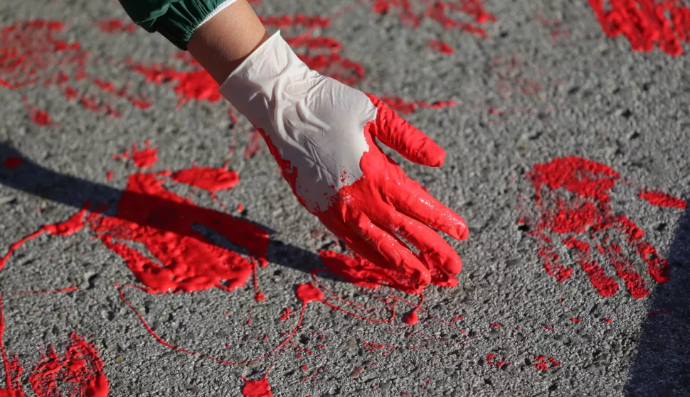 epa11751321 A protestor makes red hand imprints symbolizing blood during the one month anniversary of the Novi Sad train station accident in Novi Sad, Serbia, 01 December 2024. Fifteen people lost their lives in the collapse of the Novi Sad Railway Station canopy on 01 November 2024. The station building, which had been renovated and reopened on 05 July 2024, was undergoing further renovations shortly before the collapse. EPA/ANDREJ CUKIC