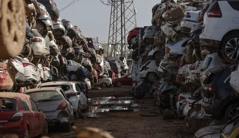 epa11748944 Flood-damaged vehicles are piled-up in Paiporta, Valencia province, 30 November 2024. The automobile sector is expecting 'a totally anomalous behavior' of demand in the Valencian region over the next few months following the floods triggered by the DANA (high-altitude isolated depression) weather phenomenon on 29 October that rendered over 100,000 vehicles unusable and still affect forty dealerships. EPA/MANUEL BRUQUE