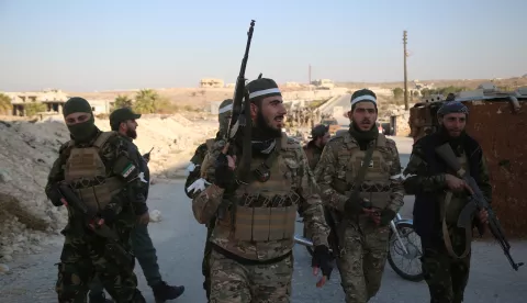 epa11750162 Opposition fighters patrol the streets after they took control of the city of Maarat al-Numan where the international road M5 passes through it, in Maarat al-Numan, Syria, 30 November 2024, following a large offensive by rebel forces November 27, taking large parts of the country's second-biggest city. The offensive triggered Russian strikes on Aleppo 30 November 2024, the first since 2016, and saw Syria's military withdraw its troops from the city. The attack was led by the Islamist militant group Hayat Tahrir al-Sham (HTS). EPA/BILAL AL HAMMOUD