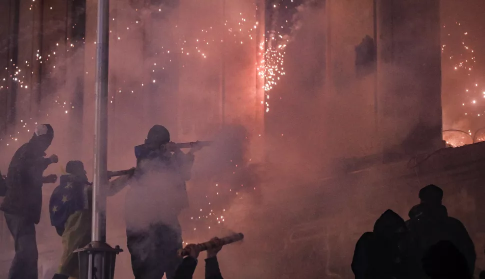 epa11752439 Georgian opposition supporters launch fireworks towards the Parliament building during protest in Tbilisi, Georgia, 01 December 2024. Thousands of pro-EU activists demonstrated in the Georgian capital of Tbilisi to protest against the country's ruling party decision to suspend accession talks with the European Union (EU) until the end of 2028. EPA/DAVID MDZINARISHVILI