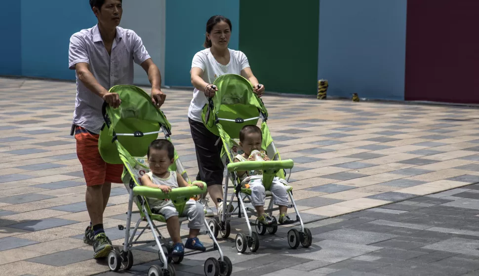 epa06942380 Parents with their children walk in the Sanlitun area of Beijing, China, 10 August 2018 (issued 11 August 2018). In 2016 China took the historic step of ending its 'one-child policy', allowing all couples to have two children, but the measure does not seem to have been enough to solve the demographic problems. According to the National Health Commission of China, Chinese elderly, who currently represent 17.3 percent of the total population, will rise to 34.9 percent in 2050 (487 million), posing serious problems for the future of the country. China is reportedly considering ending birth limits in the near future. EPA/ROMAN PILIPEY