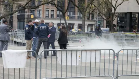 epa11289325 Emergency personnel asses the scene where a man set himself on fire at Collect Pond Park, outside Manhattan Criminal Court, where former president Donald Trump is attending jury selection for his criminal trial, in New York, USA, 19 April 2024. The New York City Police Department confirmed on 19 April that a man walked to the center of the park directly opposite the New York County Criminal Court and threw some pamphlets in the air before setting himself on fire. The individual was then moved to a hospital where he was admitted in critical conditions. EPA/SARAH YENESEL