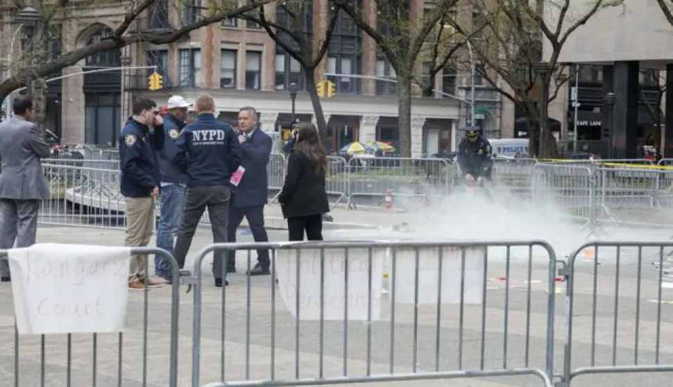 epa11289325 Emergency personnel asses the scene where a man set himself on fire at Collect Pond Park, outside Manhattan Criminal Court, where former president Donald Trump is attending jury selection for his criminal trial, in New York, USA, 19 April 2024. The New York City Police Department confirmed on 19 April that a man walked to the center of the park directly opposite the New York County Criminal Court and threw some pamphlets in the air before setting himself on fire. The individual was then moved to a hospital where he was admitted in critical conditions. EPA/SARAH YENESEL