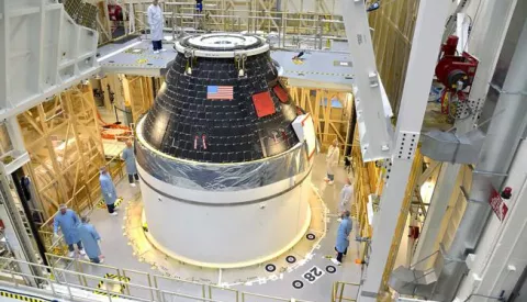 epa04391151 A handout picture dated 07 September 2014 and made available by NASA on 08 September 2014 shows NASAs first completed Orion crew module, sitting atop its service module at the Neal Armstrong Operations and Checkout Facility at Kennedy Space Center in Florida. The crew and service module will be transferred together on 10 September 2014 to another facility for fueling, before moving again for the installation of the launch abort system. At that point, the spacecraft will be complete and ready to stack on top of the Delta IV Heavy rocket that will carry it into space on its first flight in December. For that flight, Exploration Flight Test-1, Orion will travel 3,600 miles above the Earth  farther than any spacecraft built to carry people has traveled in more than 40 years  and return home at speeds of 20,000 miles per hour, while enduring temperatures near 4,000 degrees Fahrenheit. EPA/RAD SINYAK/HANDOUT HANDOUT EDITORIAL USE ONLY