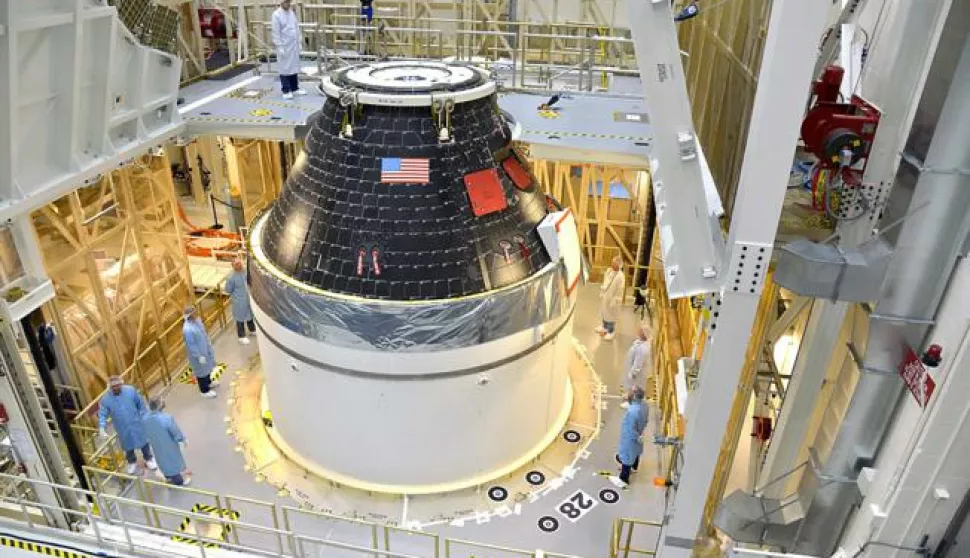 epa04391151 A handout picture dated 07 September 2014 and made available by NASA on 08 September 2014 shows NASAs first completed Orion crew module, sitting atop its service module at the Neal Armstrong Operations and Checkout Facility at Kennedy Space Center in Florida. The crew and service module will be transferred together on 10 September 2014 to another facility for fueling, before moving again for the installation of the launch abort system. At that point, the spacecraft will be complete and ready to stack on top of the Delta IV Heavy rocket that will carry it into space on its first flight in December. For that flight, Exploration Flight Test-1, Orion will travel 3,600 miles above the Earth  farther than any spacecraft built to carry people has traveled in more than 40 years  and return home at speeds of 20,000 miles per hour, while enduring temperatures near 4,000 degrees Fahrenheit. EPA/RAD SINYAK/HANDOUT HANDOUT EDITORIAL USE ONLY