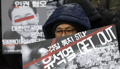 epa11758032 Members of the Korean Confederation of Trade Unions (KCTU) hold placards reading 'Yoon, get out' during a demonstration calling for the dismissal and impeachment of South Korean president in Seoul, South Korea, 05 December 2024. South Korean President Yoon Suk Yeol faces an impeachment motion from opposition lawmakers after he declared and then reversed martial law, citing the need to root out pro-North Korean forces and uphold the constitutional order. EPA/JEON HEON-KYUN