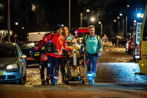 epa11761570 Emergency services transport an injured person on a stretcher near the scene after a fire and an explosion at a residential building, in The Hague, the Netherlands, 07 December 2024. The explosion blew away several apartments. EPA/JOSH WALET