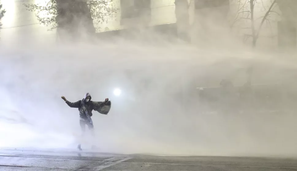 epaselect epa11761286 Police use water cannons to disperse Georgian opposition supporters protesting in front of the Parliament building in Tbilisi, Georgia, 06 December 2024. Thousands of pro-EU activists continue their protests in the Georgian capital against the country's ruling party decision to suspend accession talks with the European Union (EU) until the end of 2028. EPA/DAVID MDZINARISHVILI