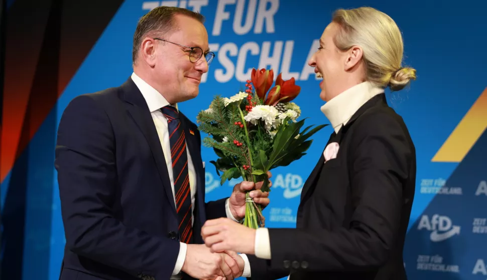 epa11761837 Alternative for Germany (AfD) party and faction co-chairwoman and top candidate for the federal election Alice Weidel (R) receives flowers from Alternative for Germany (AfD) party and faction co-chairman Tino Chrupalla (L), during a press conference of the Alternative for Germany (AfD) in Berlin, Germany, 07 December 2024. The Alternative for Germany (AfD) party held a press conference to present their Chancellor candidate ahead of the upcoming German federal election. EPA/CLEMENS BILAN