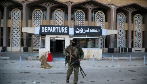 epa11752859 An armed man stands in front of the departure hall of Aleppo International Airport in Aleppo, Syria, 02 December 2024. According to the Syrian Observatory for Human Rights (SOHR) on 30 November, militants opposing the Syrian government, seized Aleppo International Airport. Syrian opposition forces, led by the Islamist militant group Hayat Tahrir al-Sham (HTS) launched an offensive on 27 November, taking large parts of Aleppo, Syria's second-largest city. The offensive triggered counterattacks by the Syrian regime forces as well as Russian and Syrian airstrikes on opposition-controlled areas. More than 400 people, including civilians and militants have been killed since 27 November, SOHR stated, while the United Nations Office for the Coordination of Humanitarian Affairs (OCHA) stated that over 20,000 people have been internally displaced within Aleppo and to other governorates. EPA/BILAL AL HAMMOUD