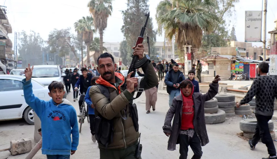 epa11764678 A fighter of the Syrian Democratic Forces (SDF) celebrates with residents after the SDF took control of the city of al-Hasakah, northeast Syria, 08 December 2024. SDF Commander-in-Chief Mazloum Abdi said in a statement on 08 December that 'Syria is living historic moments as we witness the fall of the oppressive regime in Damascus'. Syrian rebels led by Hayat Tahrir al-Sham (HTS) entered Damascus on 08 December 2024 and announced in a televised statement the 'Liberation of the city of Damascus and the overthrow of Bashar al-Assad', as well as the release of all the prisoners. EPA/AHMED MARDNLI