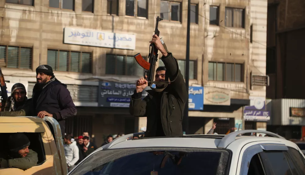 epa11765717 Syrian rebels celebrate following the takeover of Damascus, in Homs, Syria, 08 December 2024. Syrian rebels entered Damascus on 08 December 2024 and announced in a televised statement the 'Liberation of the city of Damascus and the overthrow of Bashar al-Assad', as well as the release of all the prisoners. The rebels also urged the Syrian armed forces to leave Syrian public institutions, which will stay under the control of the outgoing Syrian prime minister until the official handover ceremony. EPA/BILAL AL HAMMOUD