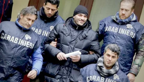 epa05151553 Alleged Camorra boss Alessandro Giannelli (C) is escorted to a police car after being arrested by Italian Carabinieri close to Caserta, near Naples, Italy, 09 February 2016. The fugitive linked to the bloody Camorra Mafia turf wars that have plagued Naples in recent months was arrested 09 February while attempting to seek refuge in Rome, Italian police said. Giannelli, 38, reportedly led of one of the dozens of Camorra clans vying for territorial control in Naples. He had been on the run since the end of last year, and was wanted for several crimes such as attempted racketeering, assault and carrying weapons illegally. EPA/CIRO FUSCO