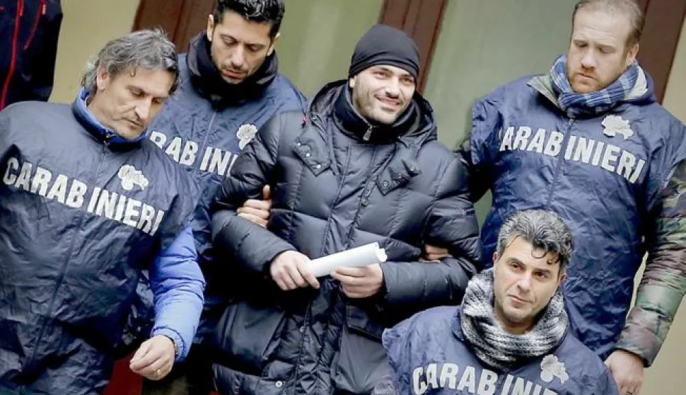 epa05151553 Alleged Camorra boss Alessandro Giannelli (C) is escorted to a police car after being arrested by Italian Carabinieri close to Caserta, near Naples, Italy, 09 February 2016. The fugitive linked to the bloody Camorra Mafia turf wars that have plagued Naples in recent months was arrested 09 February while attempting to seek refuge in Rome, Italian police said. Giannelli, 38, reportedly led of one of the dozens of Camorra clans vying for territorial control in Naples. He had been on the run since the end of last year, and was wanted for several crimes such as attempted racketeering, assault and carrying weapons illegally. EPA/CIRO FUSCO