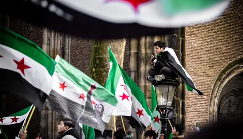 epa11765021 People carry Syrian opposition flags as they celebrate the rebel takeover of Damascus, in Utrecht, Netherlands, 08 December 2024. Syrian rebels entered Damascus on 08 December 2024 and announced in a televised statement the 'Liberation of the city of Damascus and the overthrow of Bashar al-Assad', as well as the release of all the prisoners. The rebels also urged the Syrian armed forces to leave Syrian public institutions, which will stay under the control of the outgoing Syrian prime minister until the official handover ceremony. EPA/ROB ENGELAAR