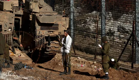 epa11766121 Israeli soldiers pray next to the border with Syria near the Druze village of Majdal Shams, in the Israeli-annexed Golan Heights, 09 December 2024. The Israeli army announced it has deployed forces to strengthen the defense of the Golan Heights and the eastern Israeli border with Syria. Syrian rebels entered Damascus on 08 December 2024 and announced in a televised statement the 'Liberation of the city of Damascus and the overthrow of Bashar al-Assad', as well as the release of all the prisoners. EPA/ATEF SAFADI