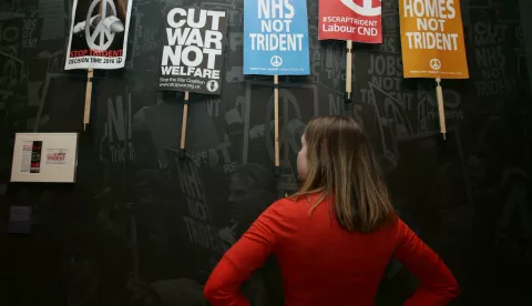 People Power: Fighting for Peace exhibition PABEST A museum staff member looking at placards gathered during an anti-Trident demonstration in London on February 27 2016, during a press view of the People Power: Fighting for Peace exhibition at the Imperial War Museum in London. Yui Mok Photo: Press Association/PIXSELL