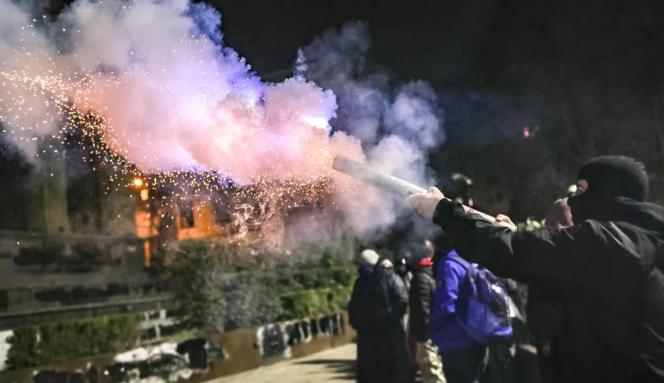 epa11761055 A supporter of the Georgian opposition launches fireworks during a protest in front of the Parliament building in Tbilisi, Georgia, 06 December 2024. Thousands of pro-EU activists continue their protests in the Georgian capital against the country's ruling party decision to suspend accession talks with the European Union (EU) until the end of 2028. EPA/DAVID MDZINARISHVILI