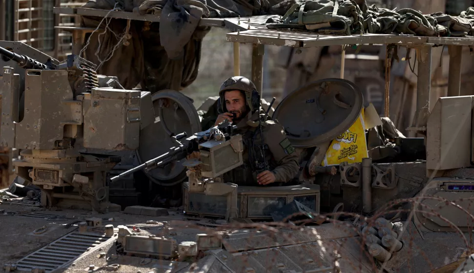 epa11774260 An Israeli soldier aboard an armoured vehicle mans a machine gun as they cross into the buffer zone between Israel and Syria, near the Druze village of Majdal Shams, in the Israeli-annexed Golan Heights, 13 December 2024. Israel's military said that paratroopers' forces, joined by other troops, are conducting 'defense activities' to prevent 'any threat' and are deployed in key positions within the buffer zone. EPA/ATEF SAFADI