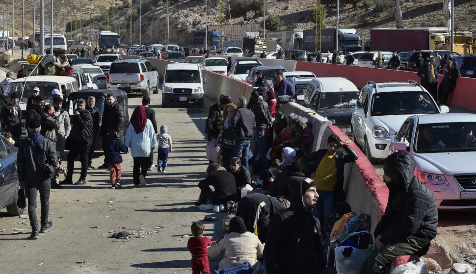 epa11776854 Syrians who fled their country wait with their belongings at the Al-Masnaa crossing as they prepare to enter Lebanon, on the Lebanese-Syrian border, Lebanon, 14 December 2024. Scores of Syrians who fled their country following the ousting of Syrian President Bashar al-Assad on 08 December, wait at the border crossing to enter Lebanon due to the unstable situation in their country. EPA/WAEL HAMZEH