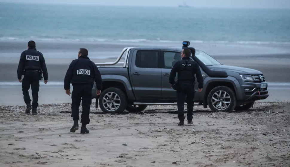 epa09602233 Policemen inspect the beach near Wimereux, France, 25 November 2021. At least 27 migrants have died and two others have been taken to hospital after a boat in which they were trying to cross the La Manche canal (English Channel) to Great Britain sank on 24 November. EPA/MOHAMMED BADRA