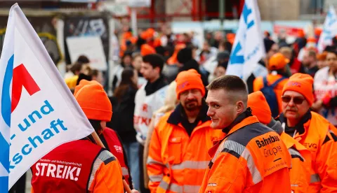 epa10545007 People attend a union demonstration in front of Ostbahnhof station during a nationwide transportation warning strike, in Berlin, Germany, 27 March 2023. German unions are calling on thousands of workers across the country's transport system to stage a one-day warning strike that is expected to bring widespread disruption to planes, trains and local transit. EPA/HANNIBAL HANSCHKE