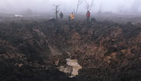 epaselect epa10511280 Locals gather around a shelling crater after a rocket hit the Pisochyn neighborhood outside Kharkiv, Ukraine, 09 March 2023. Ukrainian authorities said on 09 March that Russia fired 81 missiles across the country targeting critical infrastructure and residential buildings. The country's Defense Ministry confirmed that 34 cruise missiles were shot down. According to Ukraine's nuclear operator Energoatom, the Zaporizhzhia nuclear power plant (NPP) lost power as a result of the missile attacks, and was running on diesel generators. EPA/PAVLO PAKHOMENKO