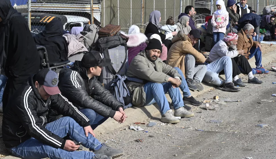 epa11766781 People, including Syrian citizens, wait with their belongings after they arrived from Syria, at the Al-Masnaa crossing on the Lebanese-Syrian border, Lebanon, 09 December 2024. Lebanese Caretaker Interior Minister Bassam Mawlawi on 09 December called on Lebanese authorities to 'take immediate measures to prevent illegal crossings by Syrians' urging Internal Security Forces to 'deploy reinforcements, secure the crossing, and establish checkpoints', according to Lebanon's National News Agency (NNA). Syrian rebels entered Damascus on 08 December 2024 and announced in a televised statement the 'Liberation of the city of Damascus and the overthrow of Bashar al-Assad', as well as the release of all the prisoners. EPA/WAEL HAMZEH