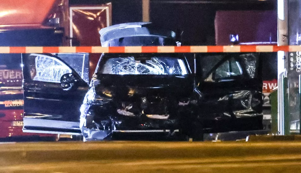 epa11787800 A damaged car at the scene after a car was driven into a crowd at the Christmas market in Magdeburg, Germany, early 21 December 2024. According to statements by the Magdeburg police on social media, two people were dead, several people were injured, and a suspect was taken into custody. EPA/FILIP SINGER