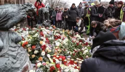 epa11788134 People lay flowers and light candles at the official mourning site in front of St. John's Church, following a vehicle-ramming attack on the Christmas market, in Magdeburg, Germany, 21 December 2024. According to Saxony-Anhalt State Premier Reiner Haseloff, five people were confirmed dead and at least 200 were injured, after a car was driven into a crowd at Magdeburg's Christmas market on 20 December. The suspect, a Saudi national, was taken into custody. EPA/FILIP SINGER