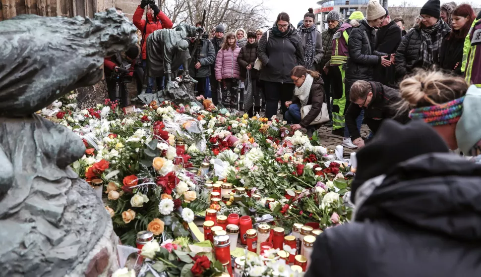 epa11788134 People lay flowers and light candles at the official mourning site in front of St. John's Church, following a vehicle-ramming attack on the Christmas market, in Magdeburg, Germany, 21 December 2024. According to Saxony-Anhalt State Premier Reiner Haseloff, five people were confirmed dead and at least 200 were injured, after a car was driven into a crowd at Magdeburg's Christmas market on 20 December. The suspect, a Saudi national, was taken into custody. EPA/FILIP SINGER