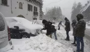 epa11764613 People walk during a snowfall in Canfranc, Huesca, Spain, 08 December 2024. EPA/JAVIER BLASCO